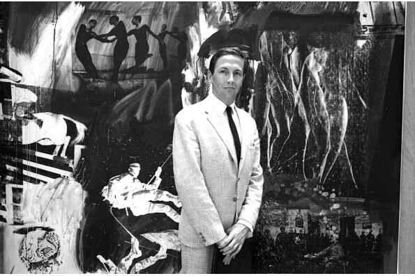 Robert Rauschenberg in front of his silkscreen painting Express at the Biennale of Art Exhibition, Venice, 1964, as seen in TAKING VENICE, a film by Amei Wallach. A Zeitgeist Films release in association with Kino Lorber. Photo: Ugo Mulas.