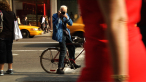Bill photographing on the streets of Manhattan. A scene from BILL CUNNINGHAM NEW YORK. A Zeitgeist Films release.