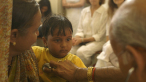 Dr. Vasant Lad with a young patient in THE DOCTOR FROM INDIA. A film by Jeremy Frindel. A Zeitgeist Films release.